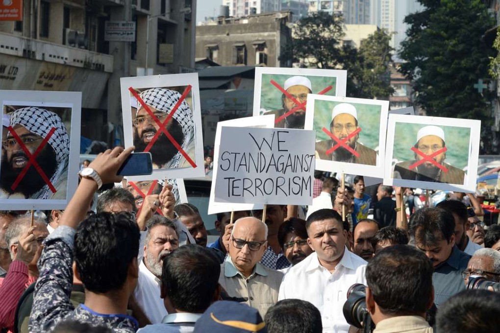 Indian activists carry photographs of the chief of Jaish-e-Mohammed, Masood Azhar during a protest against the attack on the air force base in Pathankot, in Mumbai. Photo: AFP
