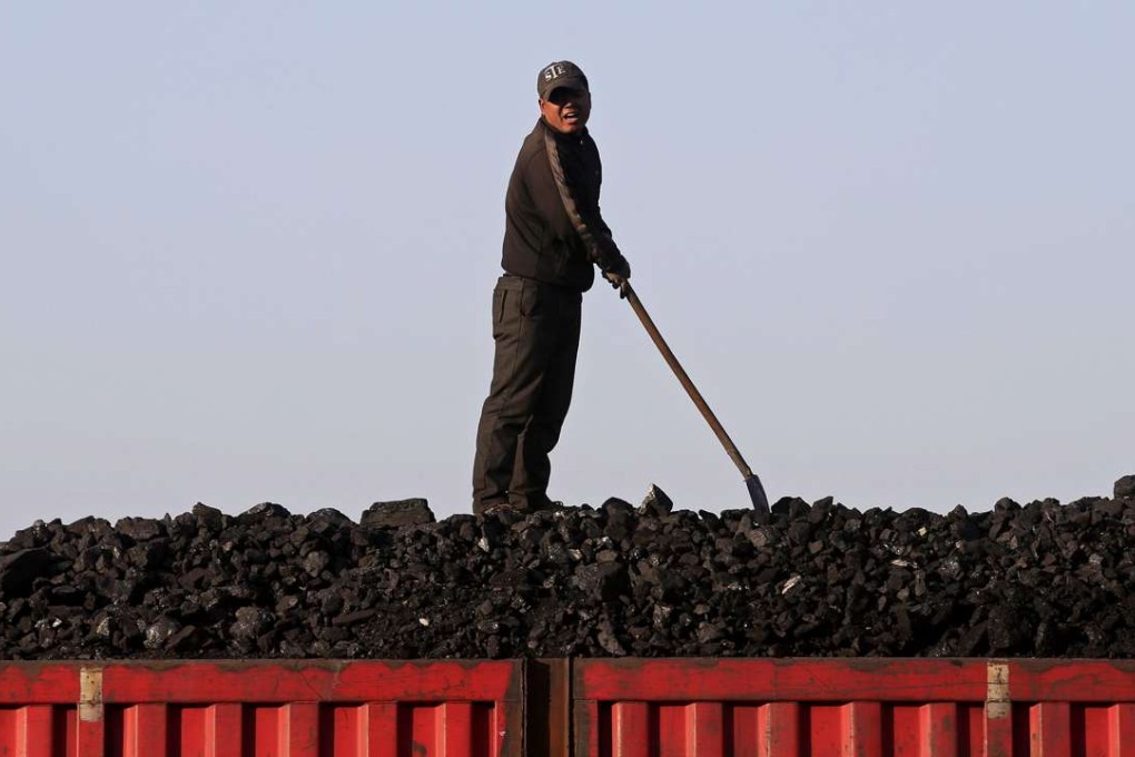 A worker loads coal on a truck at a depot near a coal mine in Heilongjiang province. Photo: Reuters