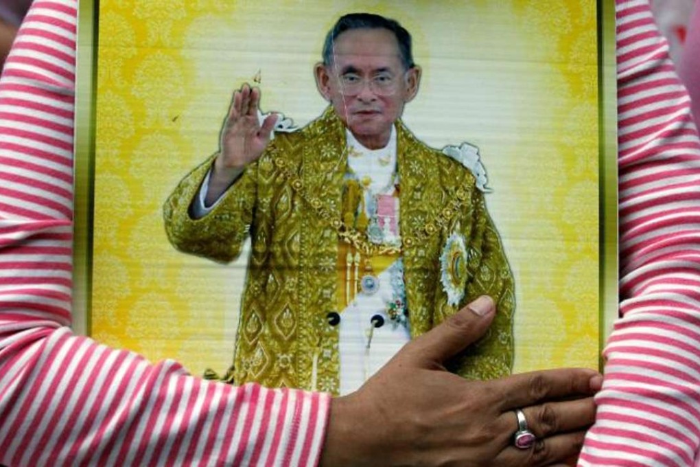 A well-wisher hugs a portrait of Thailand’s King Bhumibol Adulyadej at the Siriraj Hospital, where he died, in Bangkok. Photo: Reuters