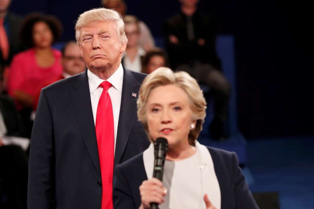Republican US presidential nominee Donald Trump listens as Democratic nominee Hillary Clinton answers a question from the audience during their presidential town hall debate at Washington University in St. Louis, Missouri, US. Photo: Reuters