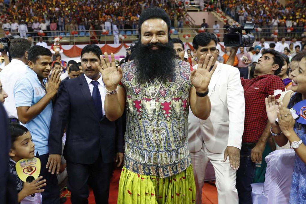 Saint Dr. Gurmeet Ram Rahim Singh Ji Insan greets followers at a press conference. Photo: AP