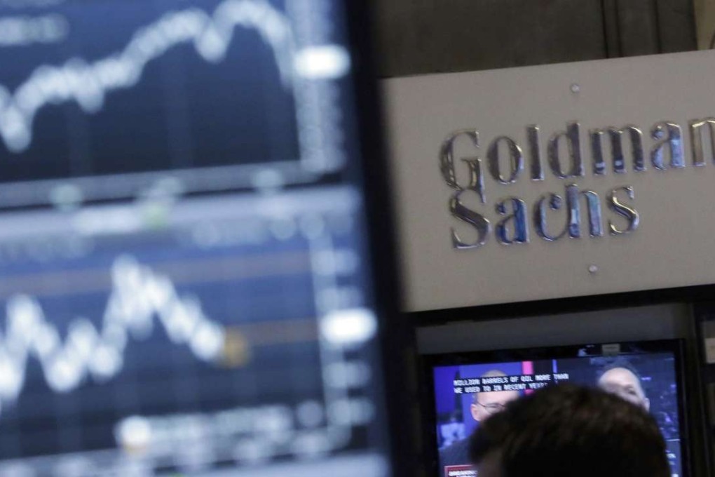 FILE - In this Oct. 16, 2014, file photo, a screen at a trading post on the floor of the New York Stock Exchange is juxtaposed with the Goldman Sachs booth. Goldman Sachs unveiled its long-awaited online consumer lending service called “Marcus” on Thursday, Oct. 13, 2016, the investment bank’s latest push to traditional retail banking products. Eligible customers will be able borrow up to $30,000 from Marcus as fixed-rate, no-fee, unsecured personal loans, with terms from two to six years. (AP Photo/Richard Drew, File)