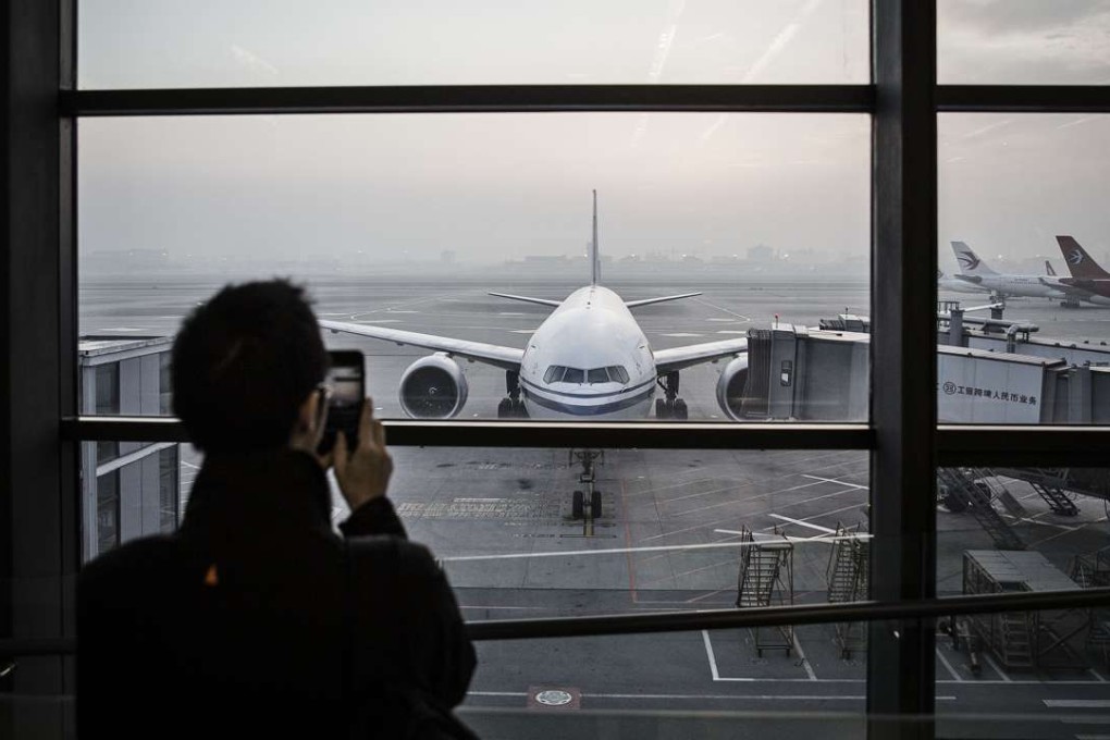 A passenger looks out over the airfield of Shanghai Hongqiao International Airport in Shanghai. Photo: Bloomberg