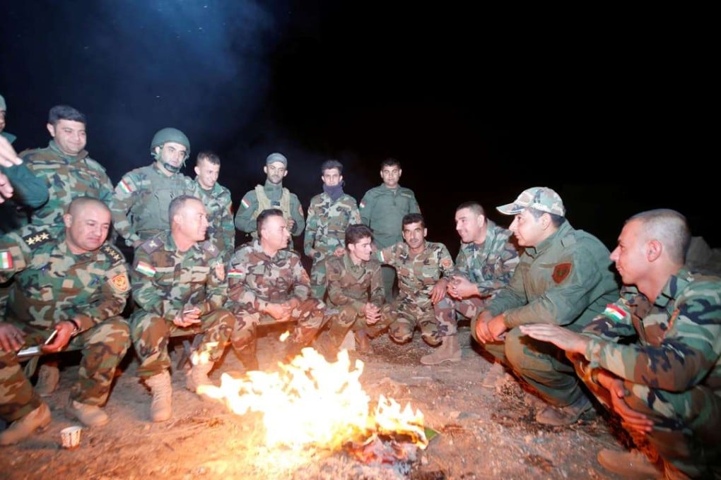 Peshmerga forces gather on the east of Mosul during preparations to attack Mosul, Iraq, late Sunday. Photo: Reuters
