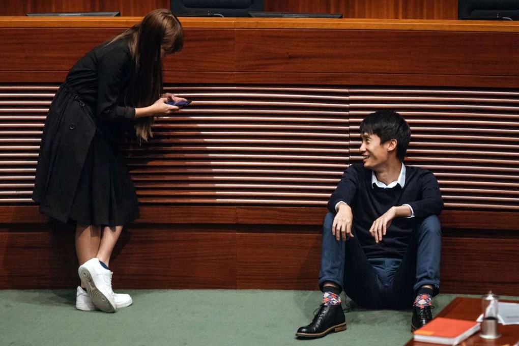 Newly elected lawmaker Yau Wai-ching speaks to her fellow Youngspiration member Sixtus “Baggio” Leung on the day of the oath-taking ceremony last week. Photo: Bloomberg