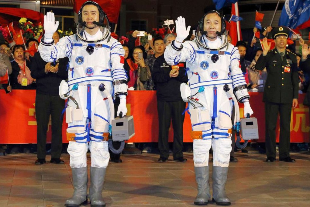 Astronauts Jing Haipeng (right) and Chen Dong wave before boarding the Shenzhou XI spacecraft at the Jiuquan Satellite Launch Centre in Inner Mongolia on Monday morning. Photo: Xinhua