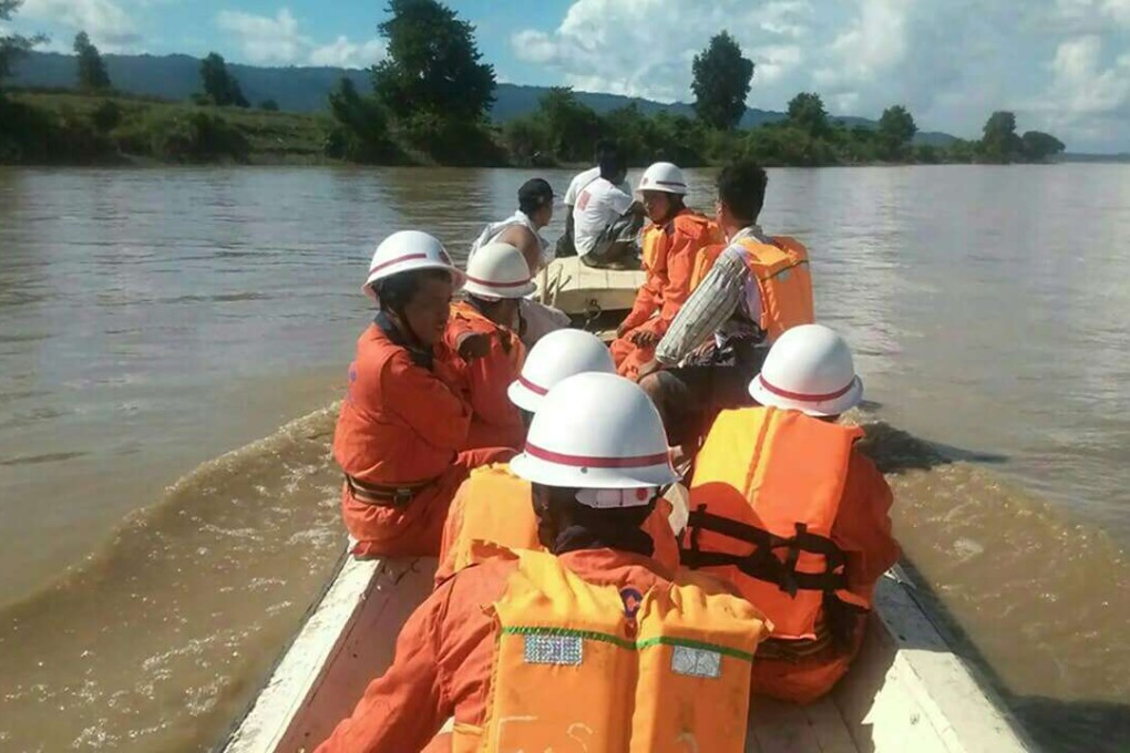 In this handout photograph released by the Myanmar Fire Services Department on October 17, 2016, government rescue personnel from the Myanmar Fire Services Deparment take part in a search operation on the Chindwin River after a ferry capsized near Monywa city in Sagaing region. Searchers have recovered 25 bodies from a ferry that sank in central Myanmar and expect to find scores more corpses as workers begin raising the boat from the riverbed, officials said on October 17. A total of 154 people have been rescued since the boat sank early on October 15 on the Chindwin River about 72 kilometres (45 miles) north of the city of Monywa. / AFP PHOTO / MYANMAR FIRE SERVICES DEPARTMENT / STR / RESTRICTED TO EDITORIAL USE - MANDATORY CREDIT "AFP PHOTO / MYANMAR FIRE SERVICES DEPARTMENT " - NO MARKETING NO ADVERTISING CAMPAIGNS - DISTRIBUTED AS A SERVICE TO CLIENTS