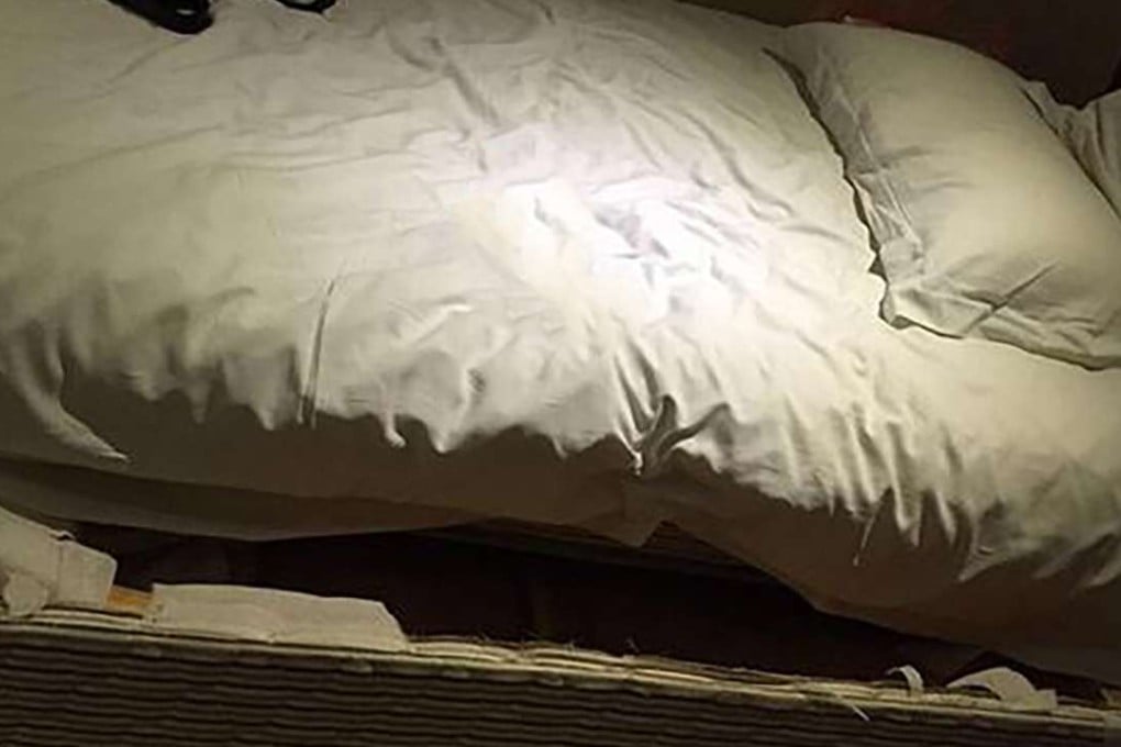 The space underneath the mattress where the hotel intruder was found hiding in Wuhan on Friday. Photo: SCMP Pictures