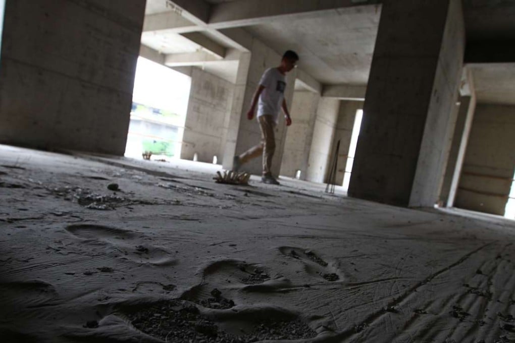 Liu Yang inspects an unfinished apartment building at Billionaire’s Lakeview Garden in Yuncheng, Shanxi province. Photo: Simon Song