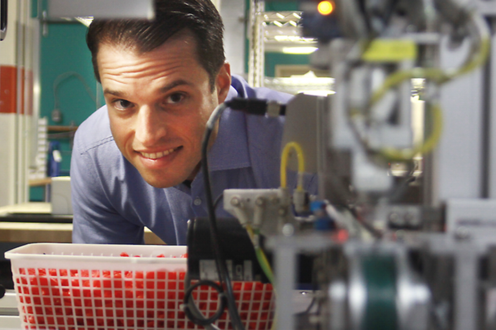 Clearly CEO Roy Hessel peers through an opening at his company's Vancouver manufacturing factility in the Broadway Tech Centre. Photo: Rob Kruyt