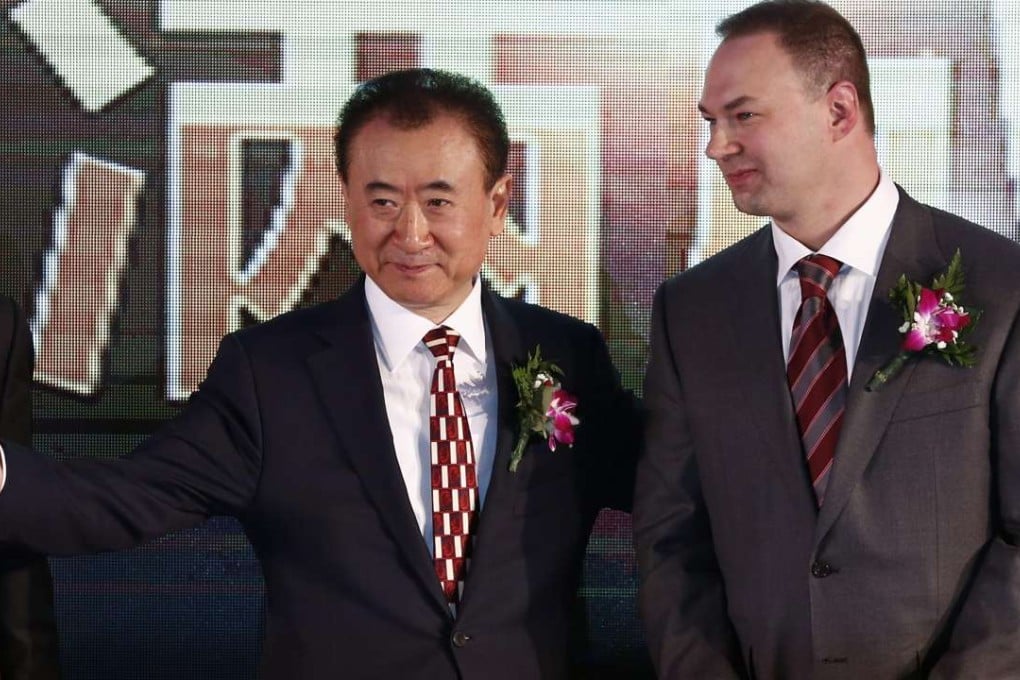 Wang Jianlin, Chairman of China's Wanda Group, with Thomas Tull (R), CEO of US film company Legendary Entertainment, finalising a merger between their respective companies. Photo: EPA