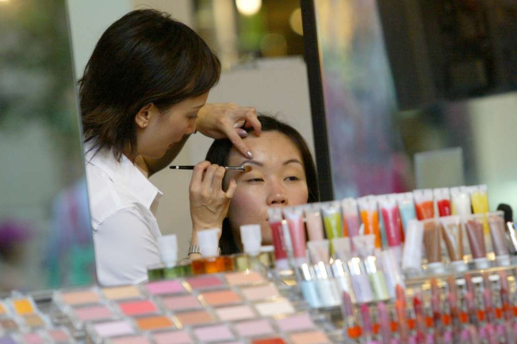 A customer gets a makeover at a cosmetics counter in Causeway Bay. Photo: David Wong