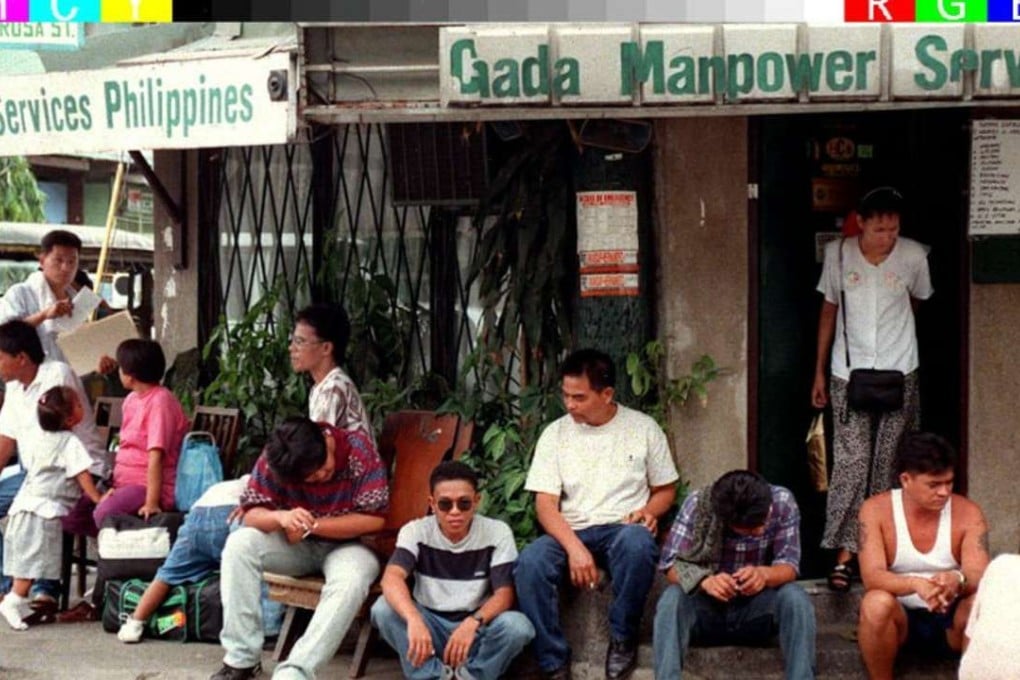 Filipino labourers applying for employment in the Middle East wait outside a job placement agency. Photo: AFP
