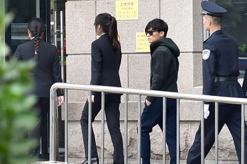 Wang Baoqiang (third from left) walks into the Beijing court before the start of the divorce hearing on Tuesday. Photo: SCMP Pictures