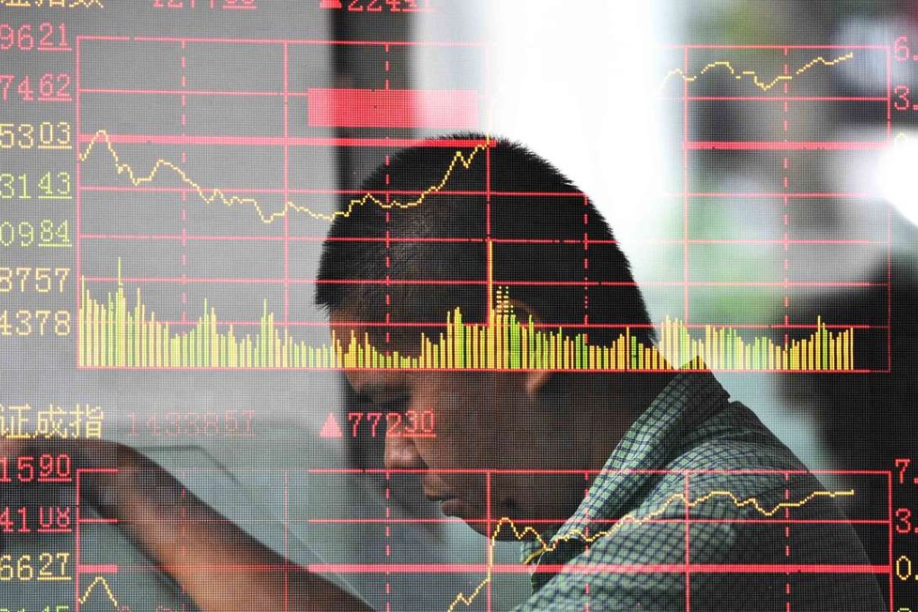An investor looks through stock information at a trading hall in a securities firm in Haikou, the capital of southeast China's Hainan Province. Photo: Xinhua