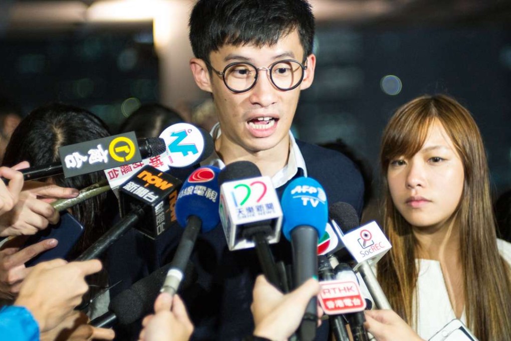 Pro-independence lawmakers Sixtus Leung and Yau Wai-ching speak to the press outside the High Court in Hong Kong on October 18. Photo: AFP