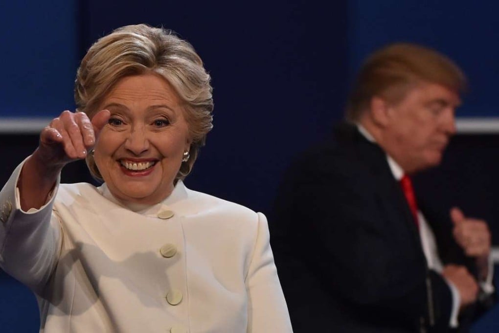 Democratic presidential nominee Hillary Clinton after the third and final US presidential debate with Republican nominee Donald Trump in the background at the Thomas & Mack Centre on the campus of the University of Las Vegas in Las Vegas, Nevada. Photo: AFP
