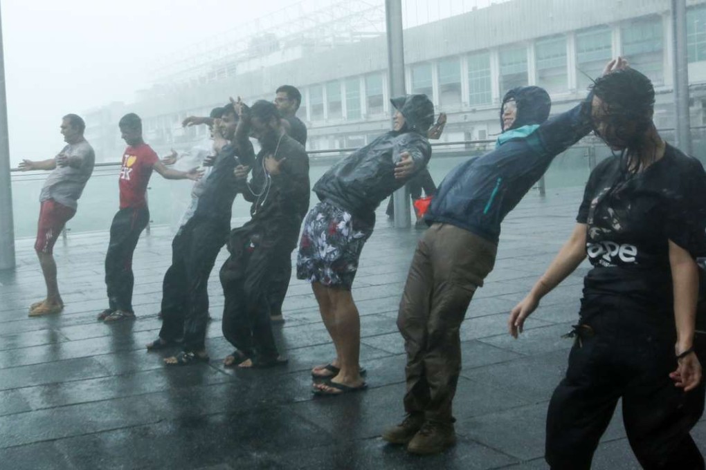 People bend with the wind outside Star Ferry in Tsim Sha Tsui. Photo: Edmond So