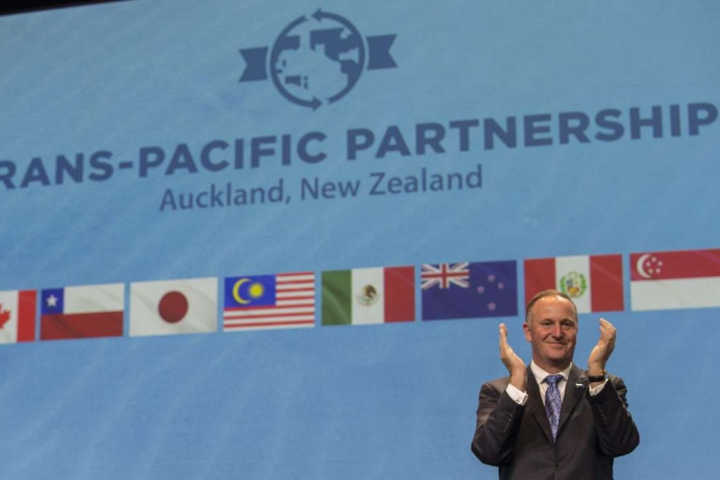 New Zealand Prime Minister John Key applauds the signing of the Trans-Pacific Partnership trade agreement in Auckland, New Zealand, in February. The 12 signatories were Australia, Brunei, Canada, Chile, Japan, Malaysia, Mexico, New Zealand, Peru, Singapore, the United States and Vietnam. Photo: EPA
