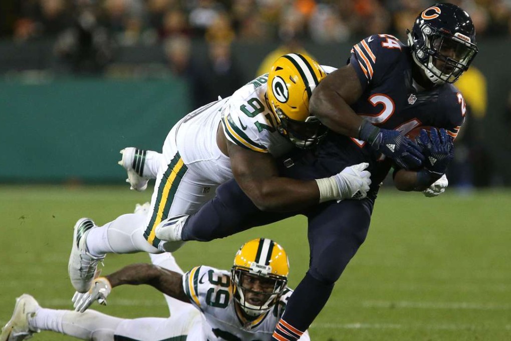 Running back Jordan Howard 2(4) of the Chicago Bears is tackled by nose tackle Kenny Clark and cornerback Demetri Goodson (39) of the Green Bay Packers in the second quarter. Photo: AFP