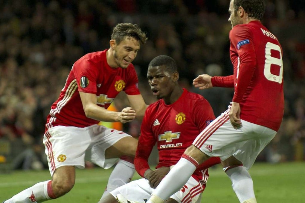 Manchester United’s Paul Pogba celebrates with Matteo Darmian (left) and Juan Mata (right) after scoring the third goal in their Europa League tie against Fenerbahce at Old Trafford. Photo: EPA