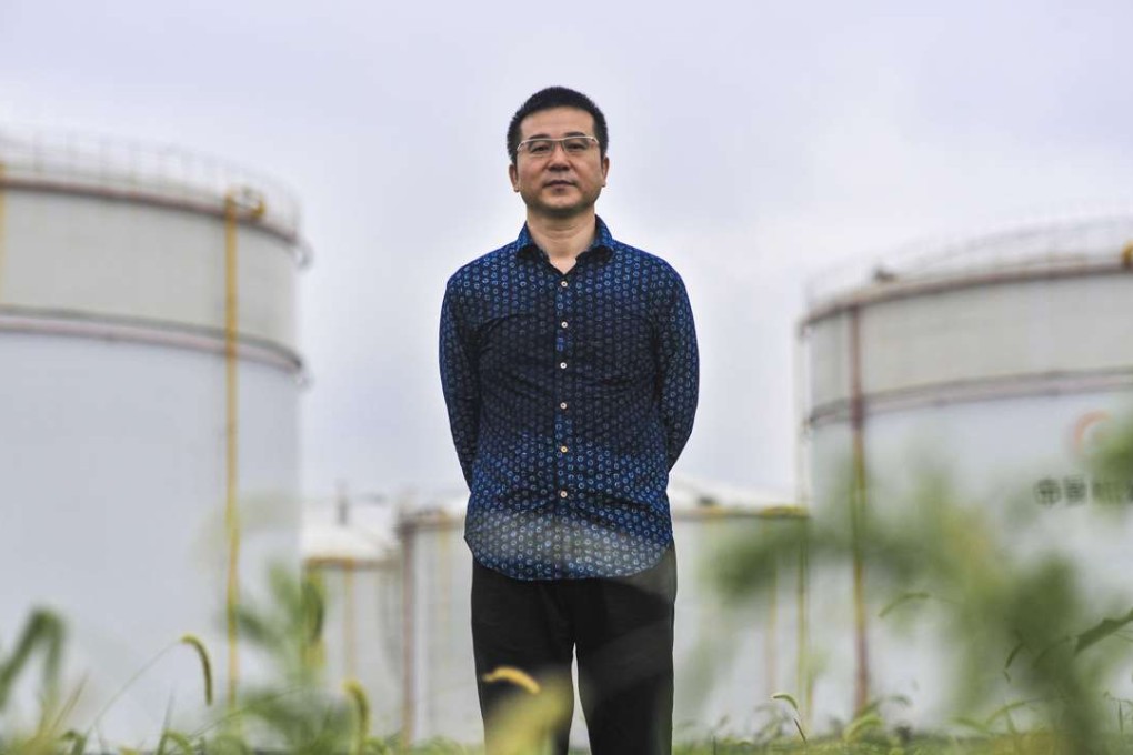Qiao Zhibing in front of the oil tanks that he is converting into a large art centre in Shanghai. Photo: Chen Zheng