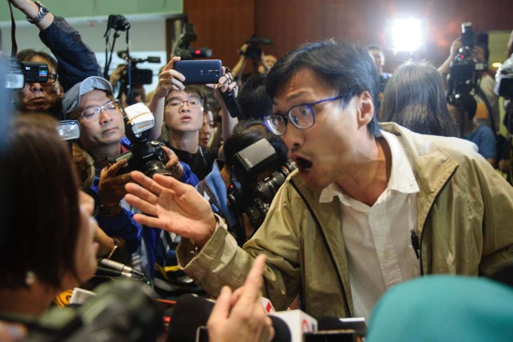 Lawmakers from opposing camps argue after the pro-establishment members walked out of the main chamber to deny localist lawmakers a second chance at being sworn in. Photo: AFP