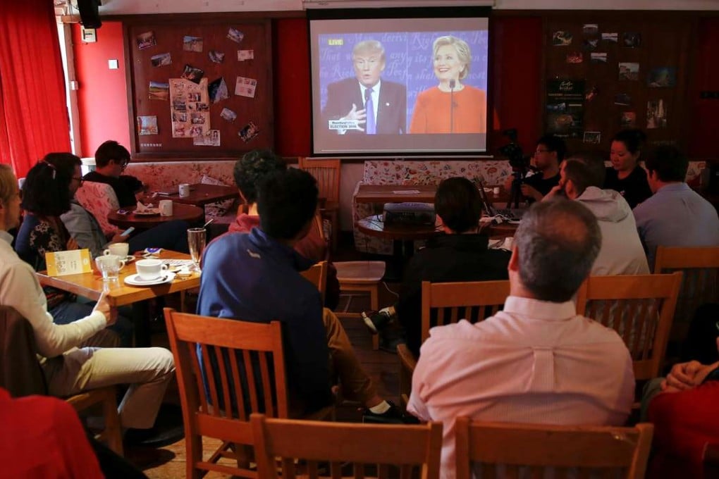 People at a cafe in Beijing watch a direct broadcast of the first US presidential debate between Republican nominee Donald Trump and Democratic nominee Hillary Clinton in September. Photo: Reuters