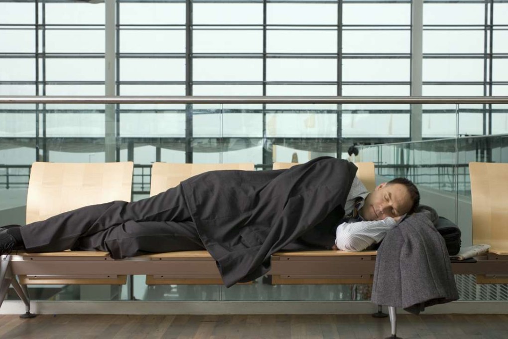 A man sleeping in an airport. Photo: Shutterstock