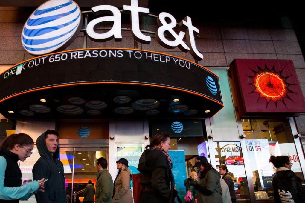 Pedestrians walk past an AT&T store in the Times Square area of New York, U.S. AT&T has agreed to buy Time Warner for $107.50 a share. Photo: Bloomberg