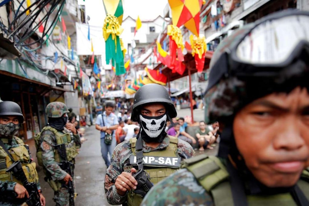 Armed security forces take a part in a drug raid in Manila. Photo: Reuters