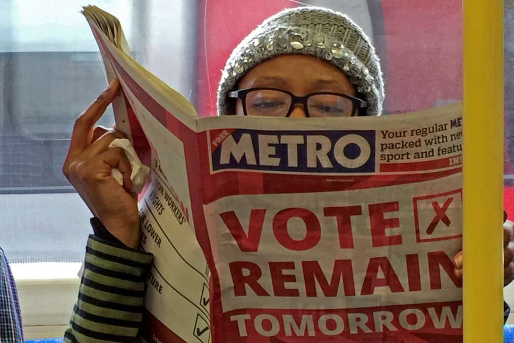 A woman reads a newspaper on the underground in London with a 'vote remain' advert for the Brexit referendum in Britain. Photo: Reuters