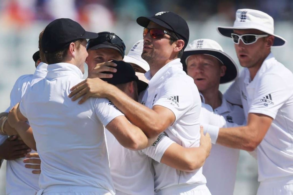 England captain Alastair Cook (C) looks relieved as he celebrates with teammates after beating Bangladesh in the first test. Photo: AFP