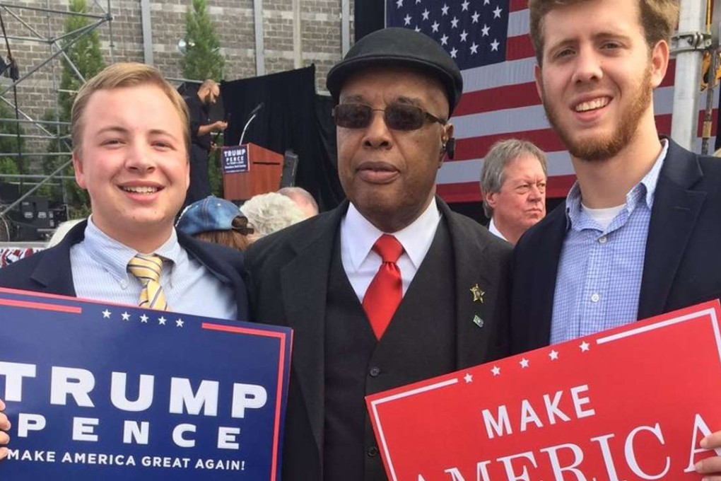 Clarence Henderson (centre), who was a hero of the civil rights movement in the 1960s, poses with fellow Trump supporters at a rally. Photo: Twitter / @chadmattk