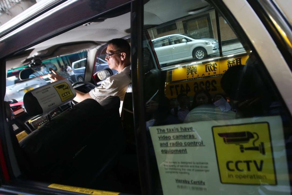 Taxi driver shows on-board surveillance cameras in a taxi. Photo: David Wong