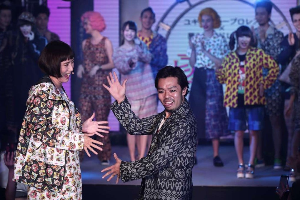 Japanese designer Yukihiro Teshima (centre) takes to the stage at the end of the Yukihero Pro-Wrestling show at Tokyo Fashion Week. Photo: AFP