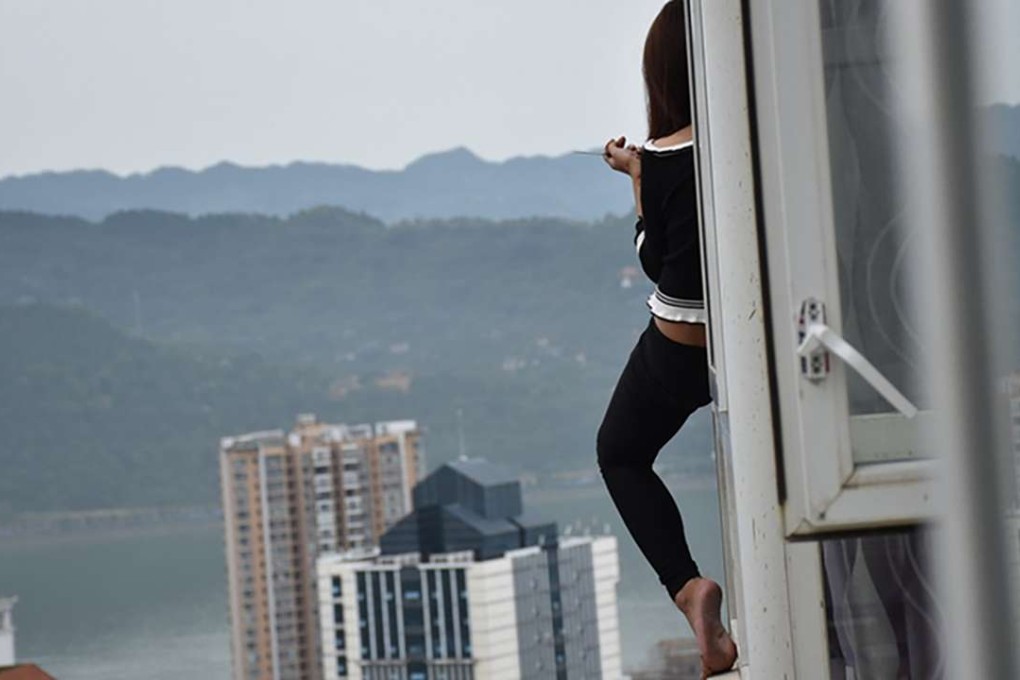 The unnamed woman rescued after sitting on the windowsill outside her 17th-storey flat was reportedly having relationship problems. Photo: SCMP Pictures