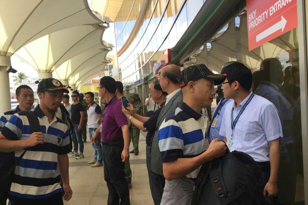 Chinese crew members in baseball caps seen before their departure from Nairobi airport. Photo: Xinhua