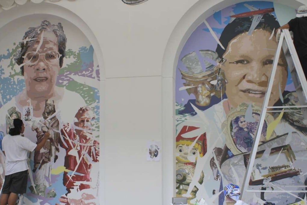 This image shows Dex Fernandez (right), painting murals in the courtyard of the Singapore Art Museum. Photos: Clara Chow