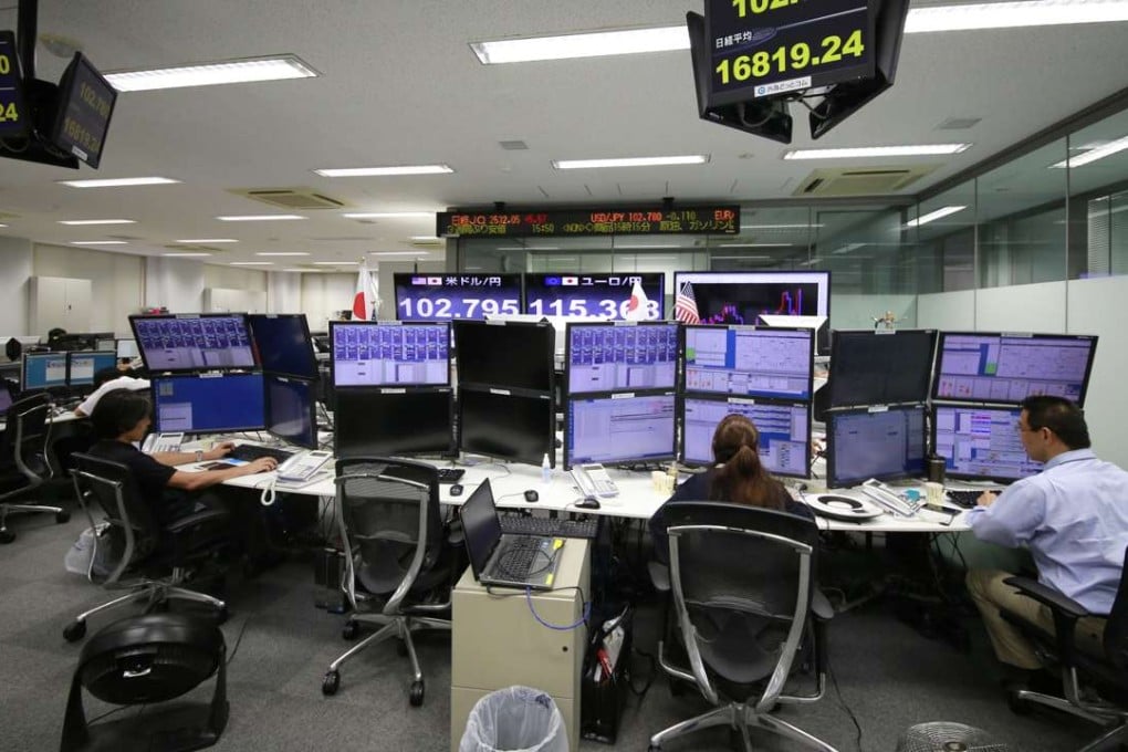 Foreigners have been net buyers of Japanese equities since early October, setting up what could be a sustained flow towards equities and a deflating Japanese yen. Photo: AP