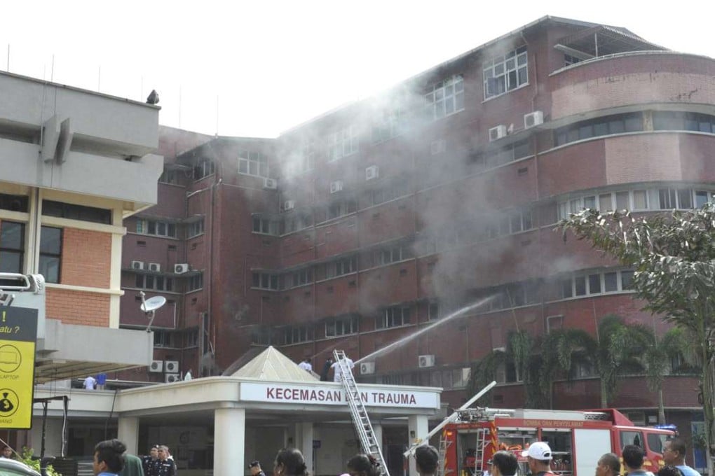 Firefighters putting out the fire which broke out on the second floor of the Intensive Care Unit at Hospital Sultanah Aminah in Johor Bahru. Photo: AP