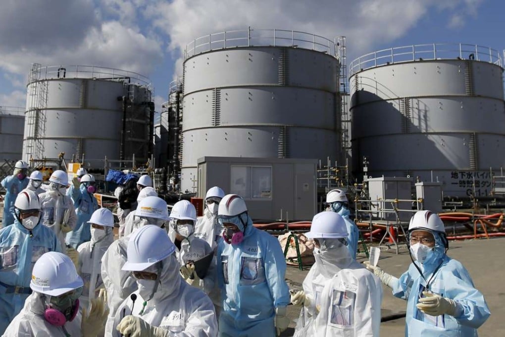Members of the media in front of storage tanks for radioactive water at Tepco's tsunami-crippled Fukushima Daiichi nuclear power plant in Okuma in February, 2016. Photo: Reuters