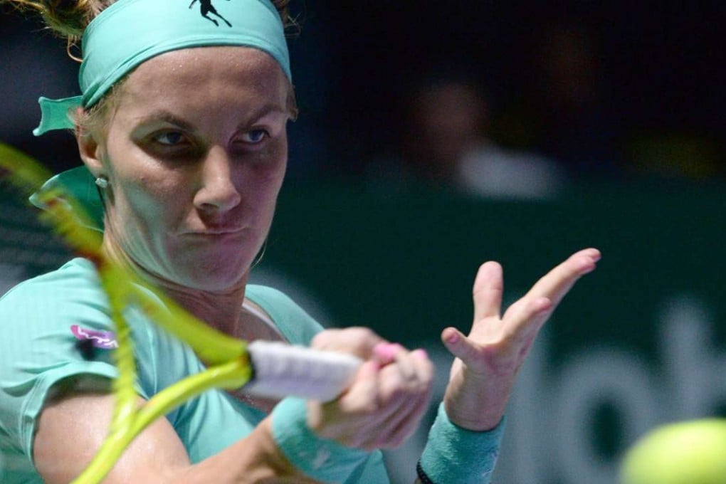 Svetlana Kuznetsova of Russia hits a return against Agnieszka Radwanska of Poland during their women's singles match at the WTA Finals tennis tournament in Singapore. Photo: AFP