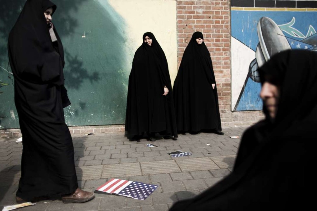 Iranian women stand outside the former US embassy in Tehran during a 2013 demonstration. Despite still being regarded as the Great Satan by the Iranian government, the US is the dream destination for hundreds of thousands of Iranian would-be emigrants each year. Photo: AFP