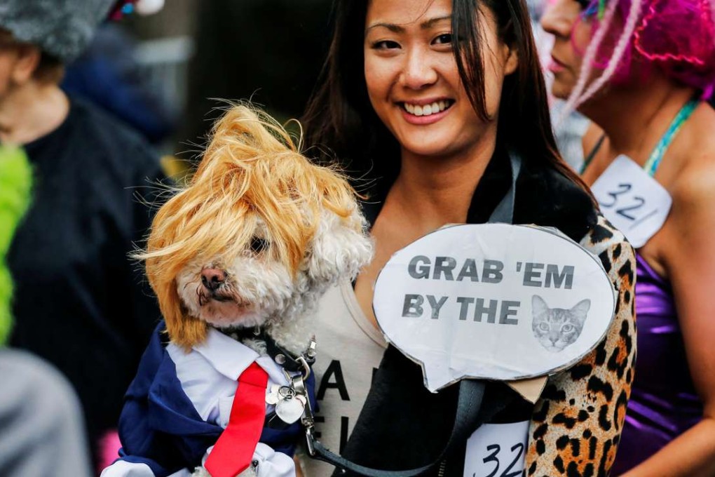A reveller carries her dog dressed up to look like Republican US presidential candidate Donald Trump during the annual Halloween dog parade in New York on October 22. Photo: Reuters