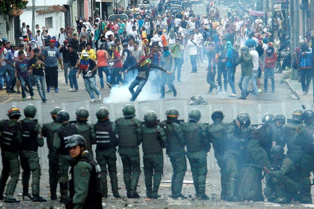 Demonstrators clash with members of Venezuelan National Guard during a rally demanding a referendum to remove Venezuela’s President Nicolas Maduro. Photo: Reuters