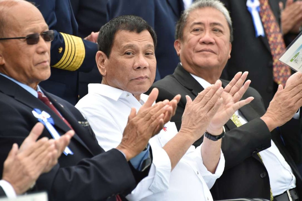 Philippine President Rodrigo Duterte, accompanied by Transportation Secretary Arthur Tugade (right) and Defence Secretary Delfin N Lorenzana (left), at a display by Japan's coast guard drills in Yokohama. Photo: Reuters