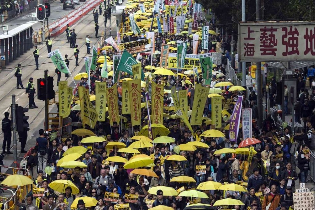 Thousands of pro-democracy protesters hold up yellow umbrellas, symbols of the Occupy movement, as they march to demand universal suffrage for Hong Kong, on February 1 last year. Photo: Reuters