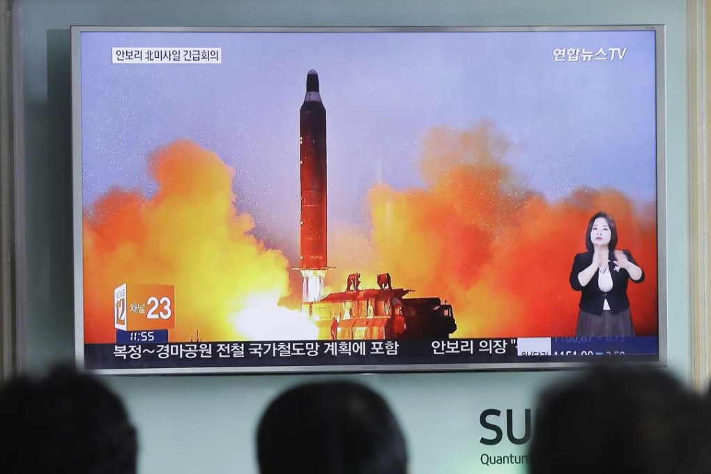 People watch a TV news channel airing an image of North Korea's ballistic missile launch published in North Korea's Rodong Sinmun newspaper at the Seoul Railway Station in Seoul. Photo: AP