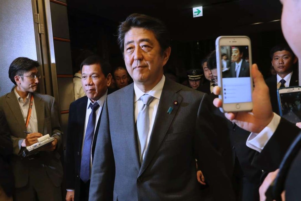 Philippine President Rodrigo Duterte is escorted by Japan's Prime Minister Shinzo Abe to a joint press conference at the prime minister's office in Tokyo. Photo: AP